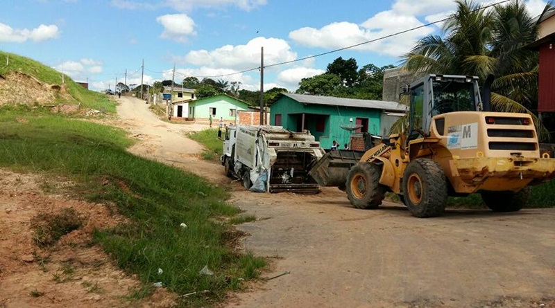 Em Cruzeiro do Sul, caminhão de lixo fica atolado em buraco, e ‘socorro’ veio de um trator para conseguir sair do local